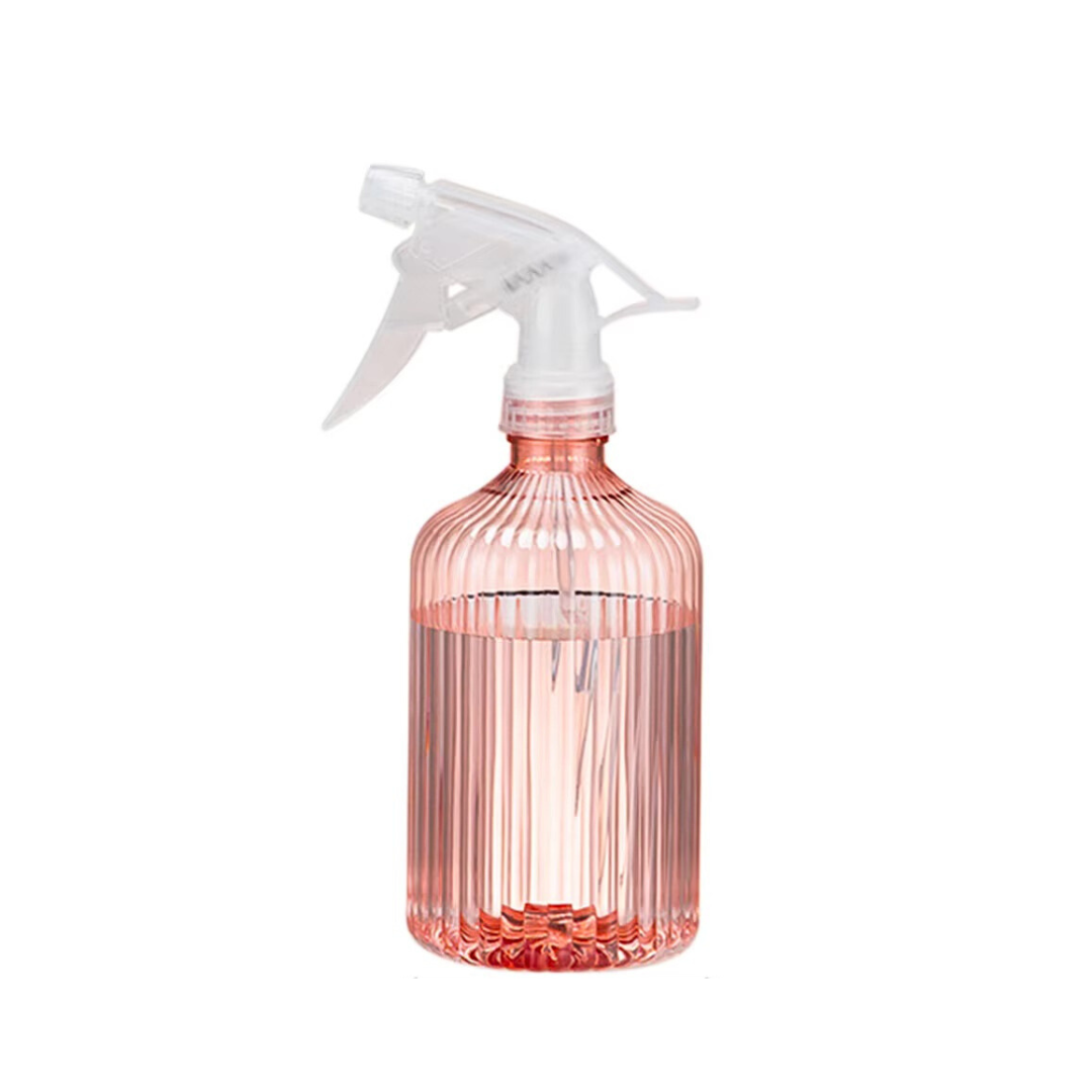 Transparent pink spray bottle