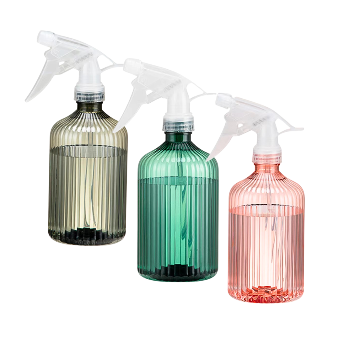 Spray bottles in grey, green, and pink