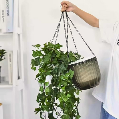 A self-watering plant pot with wicking system in grey